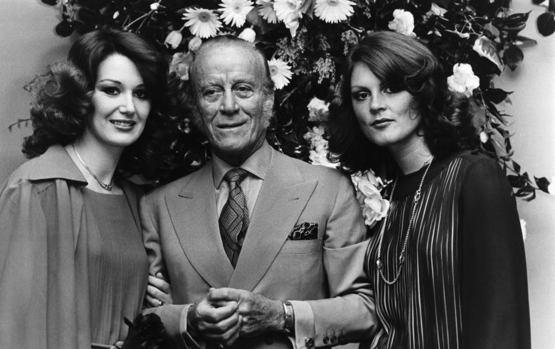The Italian fashion designer Aldo Gucci with two females at the opening of his new store on Bond Street in London, 1977. (Photo by © Hulton-Deutsch Collection/CORBIS/Corbis via Getty Images)