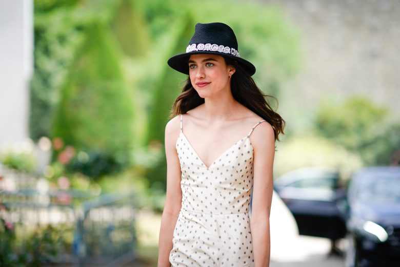 PARIS, FRANCE - JULY 02:  Margaret Qualley wears a hat, a white dress with black polka dots , outside Dior, during Paris Fashion Week Haute Couture Fall Winter 2018/2019, on July 2, 2018 in Paris, France.  (Photo by Edward Berthelot/Getty Images)